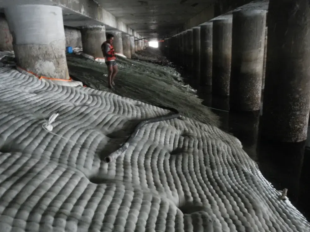 Micro-concrete being pumped into the fabric envelope