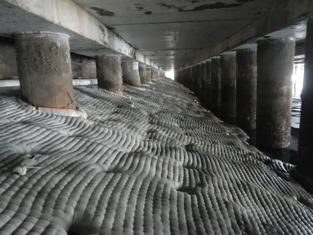 Completed continuous sealed concrete apron beneath a jetty